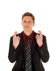 Image showing Businessman crossing his fingers.