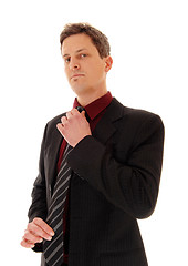 Image showing Businessman fixing his tie.