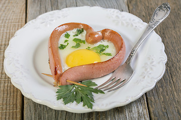Image showing Heart-shaped sausage and scrambled eggs.