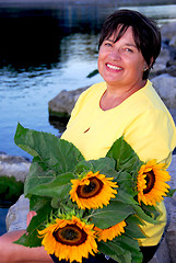 Image showing Woman sunflowers