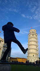 Image showing Kid kicking and fixing Pisa Tower