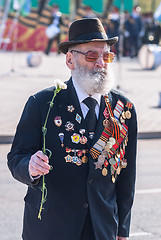 Image showing Elderly veteran of World War II walks outdoors