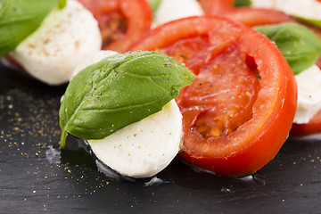 Image showing Caprese salad with mozzarella, tomato, basil and balsamic vinega