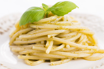 Image showing Italian pasta spaghetti with pesto sauce and basil leaf