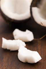 Image showing close up of a coconut on a wooden background 