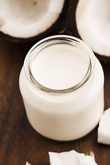 Image showing Coconut Milk in a glass on dark wooden background