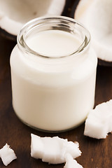 Image showing Coconut Milk in a glass on dark wooden background