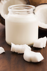 Image showing Coconut Milk in a glass on dark wooden background