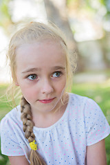 Image showing Beautiful little girl with big eyes outdoors