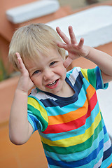 Image showing Little boy playing hide-and-seek