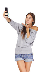 Image showing Female taking pictures of herself at smart phone