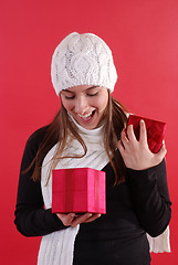 Image showing Girl surprised opening gift