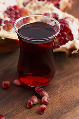 Image showing Ripe pomegranates with juice on table