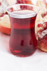 Image showing Ripe pomegranates with juice on table