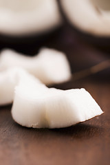 Image showing close up of a coconut on a wooden background 