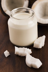 Image showing Coconut Milk in a glass on dark wooden background