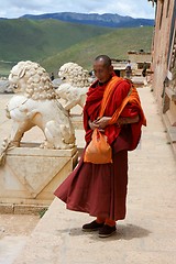 Image showing Monk in front of a Tibetan Monastery