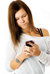 Image showing Attractive girl writing sms