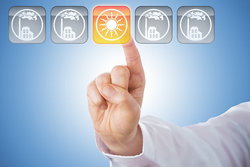 Image showing Finger Activating Yellow Solar Energy Icon On Blue