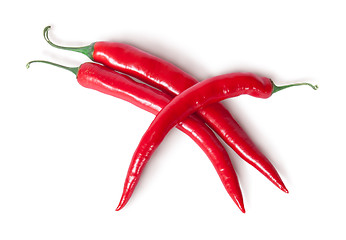 Image showing Three red chili peppers crisscross