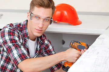 Image showing young worker with drill
