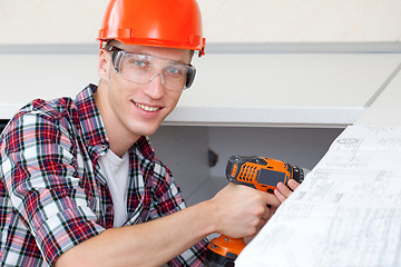 Image showing repairman with electric drill