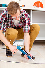 Image showing repairman repairing the floor