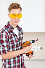 Image showing smiling builder with a dril