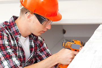 Image showing repairman with electric drill 