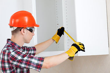 Image showing repairman with a tape measure