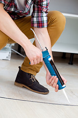 Image showing worker repairing the floor