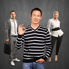 Image showing Teamwork and Asian Man In Striped Pullover