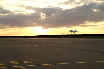 Image showing airplane setting of the sun