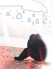 Image showing Lonely man sitting on sand