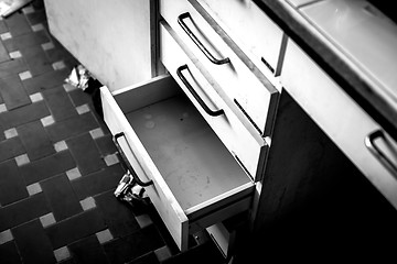 Image showing Cupboard with opened empty drawer