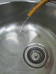 Image showing Metal sink and plastic hose