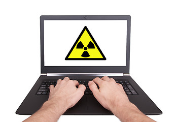 Image showing Man working on laptop, radiation