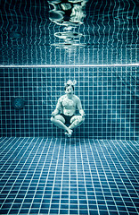 Image showing Man under water in a swimming pool to relax in the lotus positio