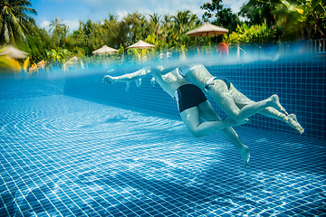 Image showing Couple floating in the pool on holiday