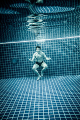 Image showing Persons standing under water in a swimming pool