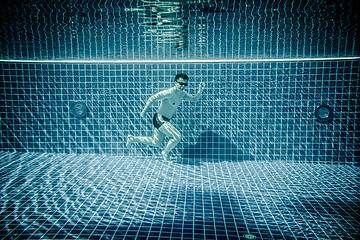 Image showing Man runs underwater swimming pool