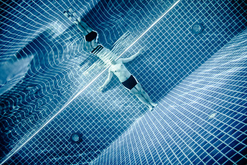 Image showing Persons standing under water in a swimming pool