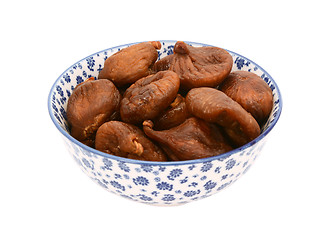 Image showing Whole dried figs in a blue and white china bowl
