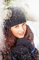 Image showing Portrait of the charming young woman in winter outdoors 