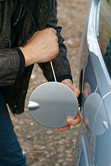 Image showing Hooligan breaking into car