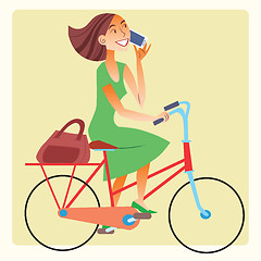 Image showing Young woman riding a bike and talking on the smartphone