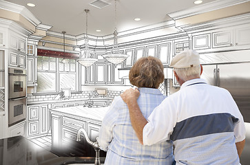 Image showing Senior Couple Looking Over Custom Kitchen Design Drawing and Pho