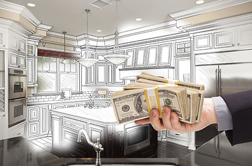 Image showing Hand Holding Cash Over Kitchen Design Drawing and Photo Combinat