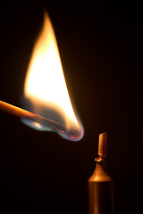 Image showing Lighting a candle.
