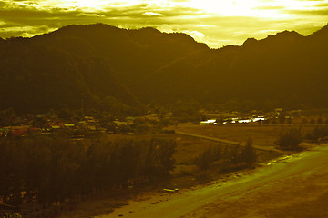 Image showing  fishing villages near mountain and sunset
